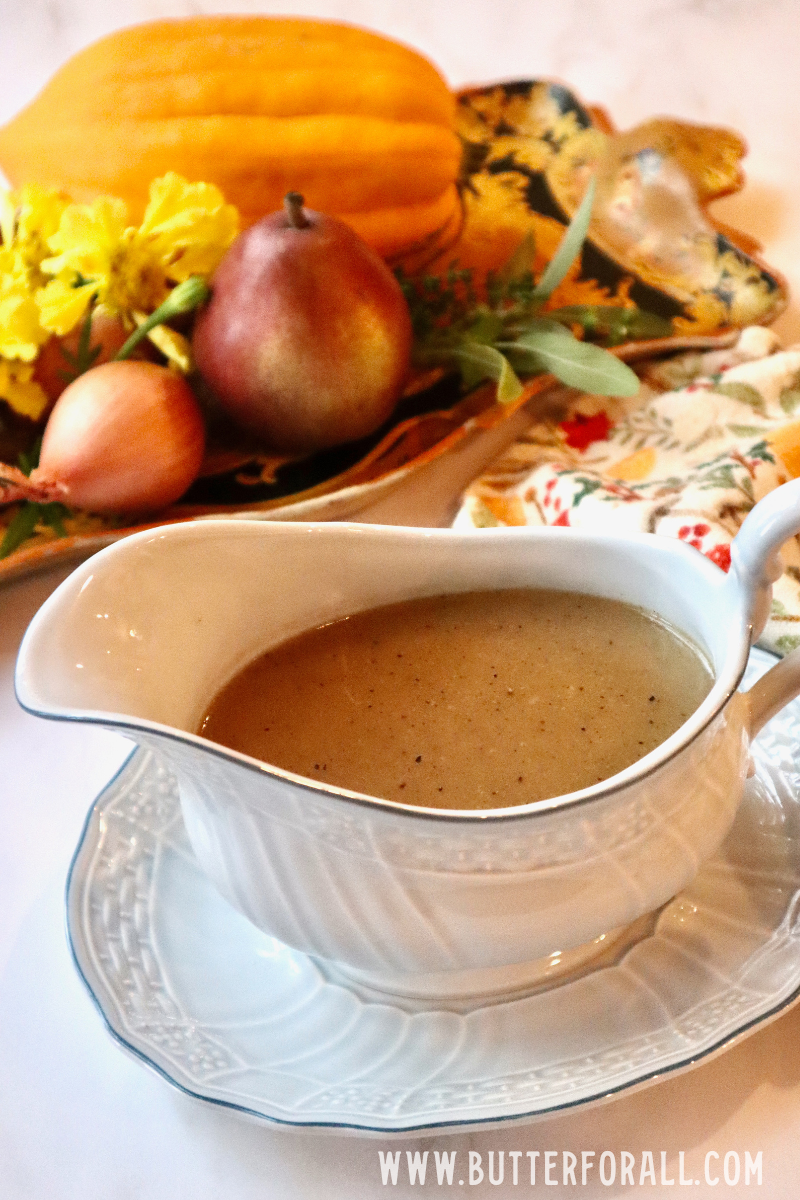 A gravy boat filled with rich, brown, sourdough-thickened gravy.